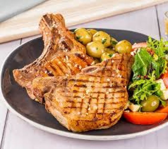 Chuleta a la parrilla con ensalada y papas fritas