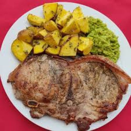Chuleta a lo Flomir en salsa barbecue con arroz y papas sancochadas
